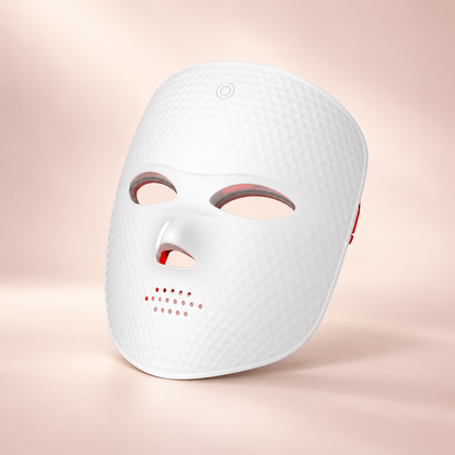 Lumière Red white LED face mask on a soft blush background