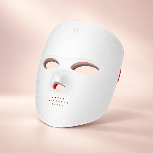 Lumière Red white LED face mask on a soft blush background